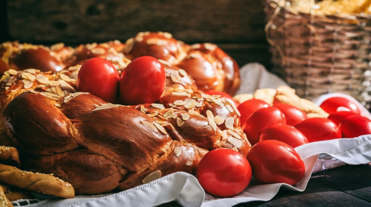 Easter traditional bread and red eggs on a table