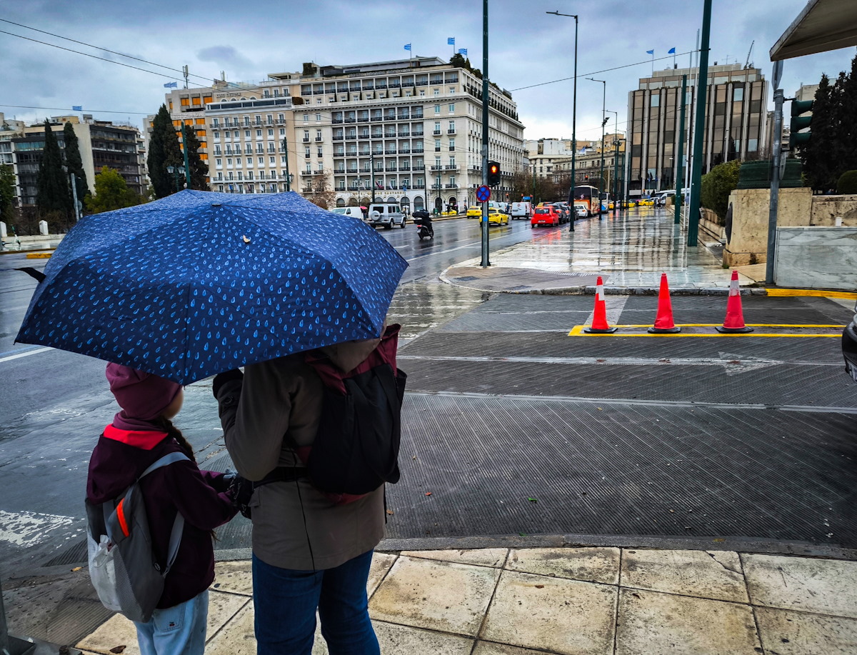 Ένα παιδί κρατάει το χέρι της μητέρας του στο κέντρο της Αθήνας