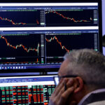 Traders work on the floor of the NYSE in New York