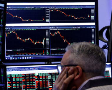 Traders work on the floor of the NYSE in New York