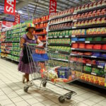 A woman uses a trolley as she shops at a Pick n Pay store
