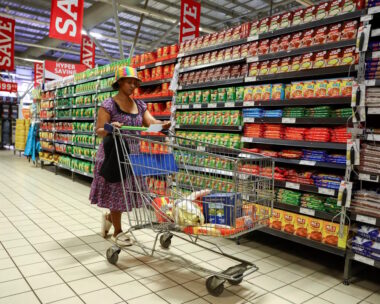 A woman uses a trolley as she shops at a Pick n Pay store
