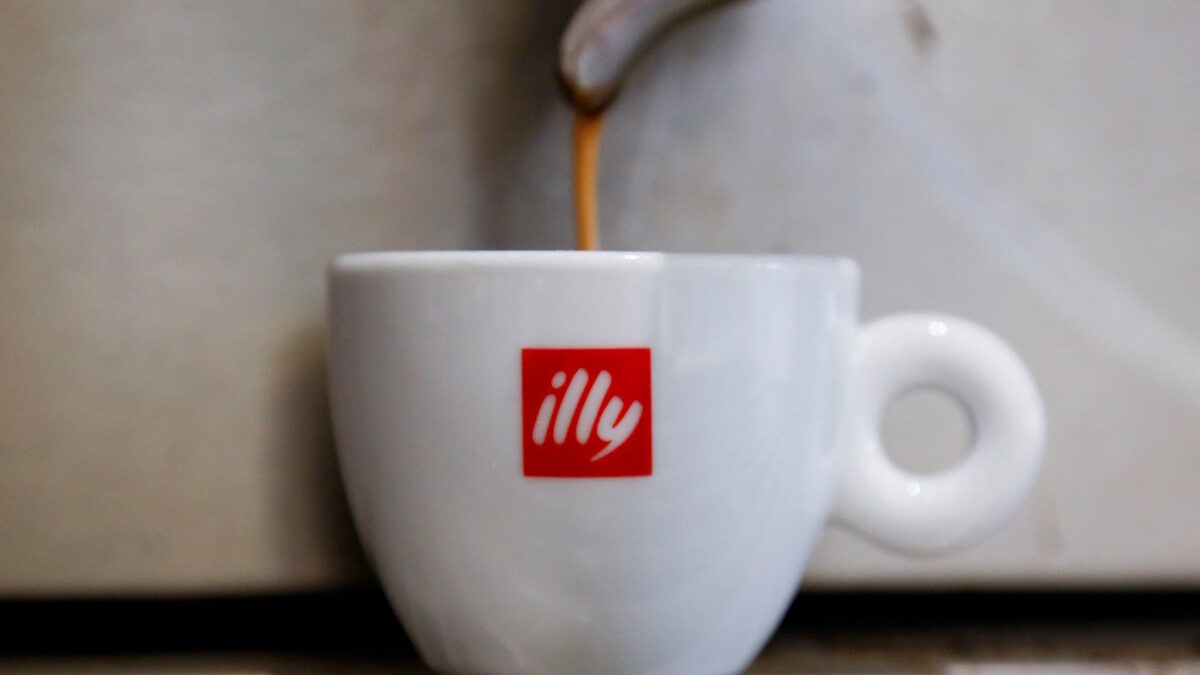 Coffee flows into a Illy cup
