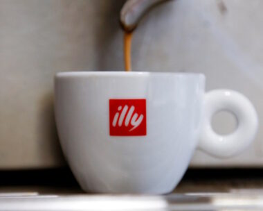 Coffee flows into a Illy cup