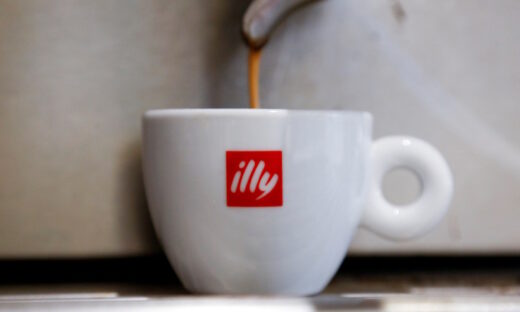 Coffee flows into a Illy cup