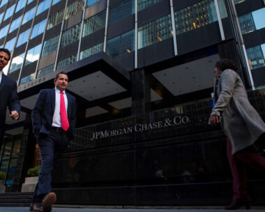 People walk by the JP Morgan building