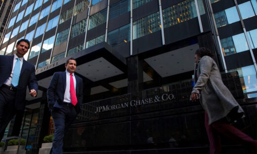 People walk by the JP Morgan building