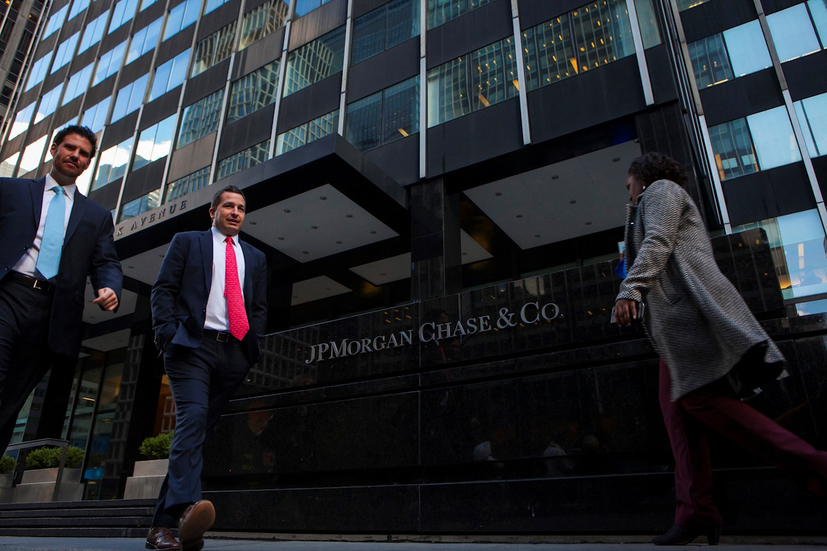 People walk by the JP Morgan building