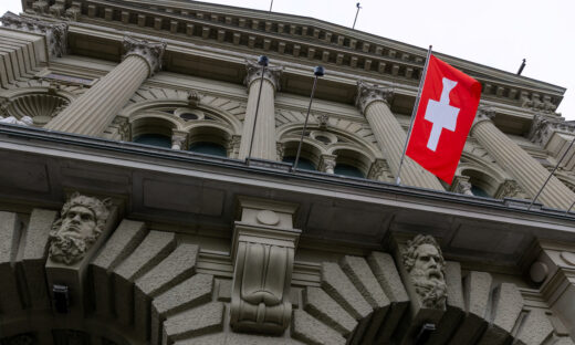 A Swiss flag hangs at the Swiss Parliament building