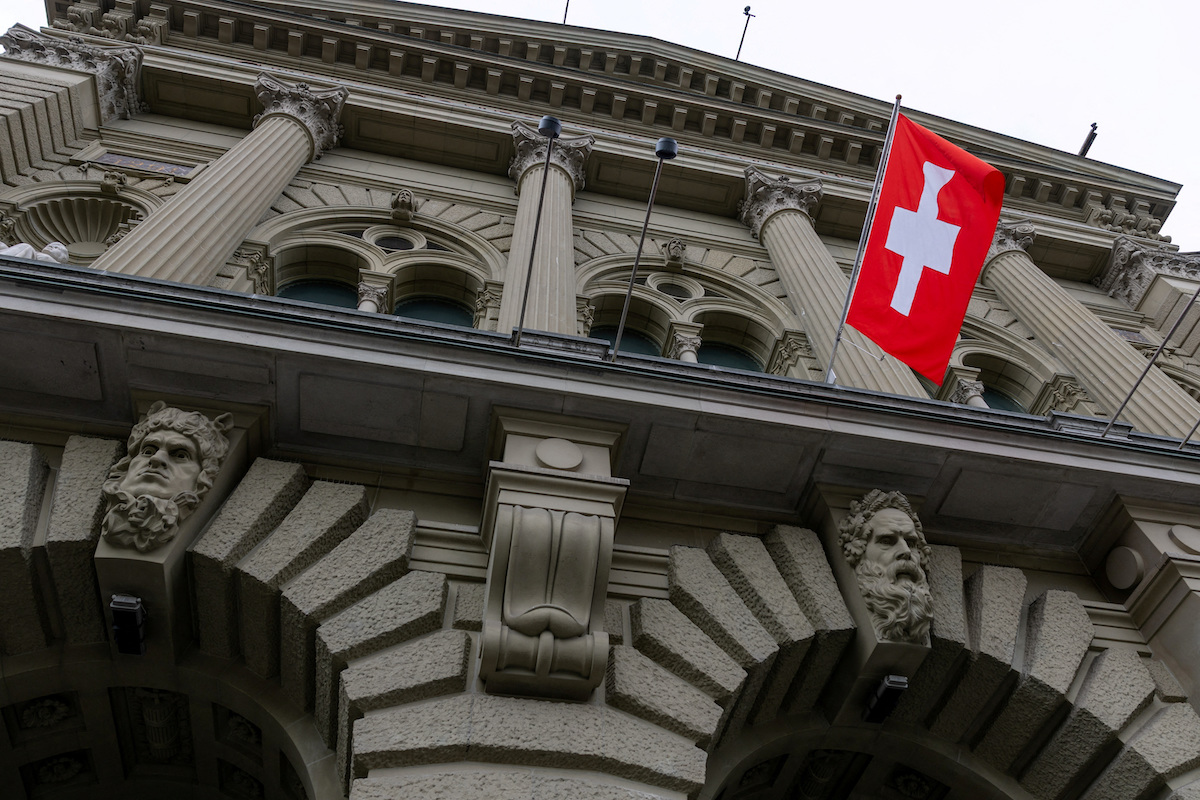 A Swiss flag hangs at the Swiss Parliament building
