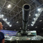 A person reacts next to a tank during LAAD, the biggest military industry expo in Latin America, in Rio de Janeiro, Brazil April 1, 2025. REUTERS