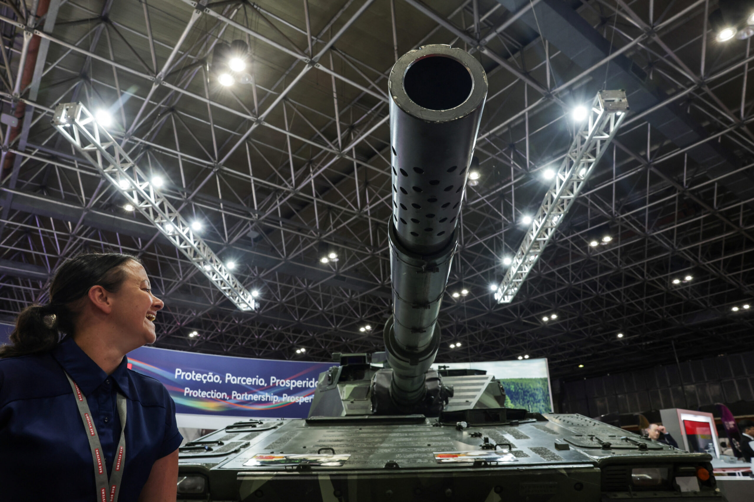 A person reacts next to a tank during LAAD, the biggest military industry expo in Latin America, in Rio de Janeiro, Brazil April 1, 2025. REUTERS