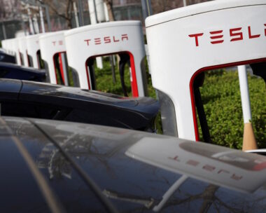 Tesla cars charge at a Supercharger charging station