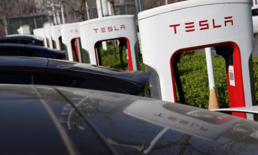 Tesla cars charge at a Supercharger charging station