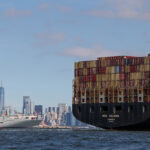 A boat carries shipping containers