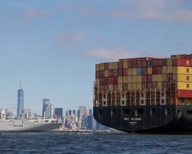 A boat carries shipping containers