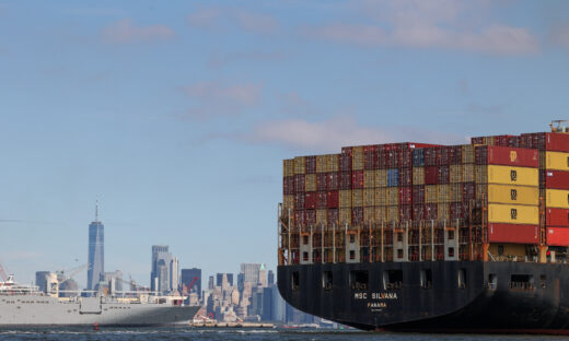 A boat carries shipping containers
