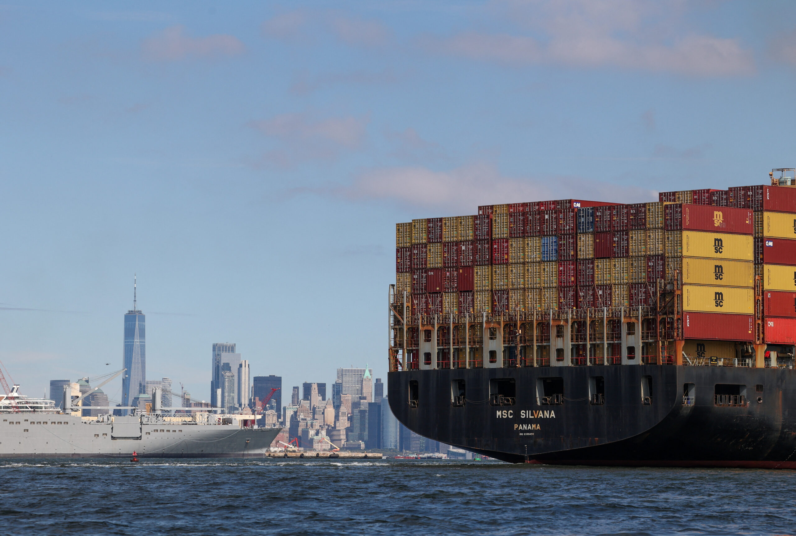 A boat carries shipping containers