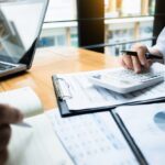 business audits using a calculator financial data investment fund at a workplace, wealth concept