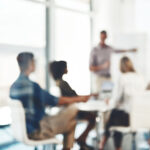 Defocused shot of a group of businesspeople having a meeting in an office