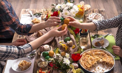 Home Holiday friends or family at the festive Easter table with Easter colored eggs. The concept of the celebration