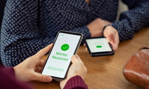 Close up of woman hands holding mobile phone with application to receive money