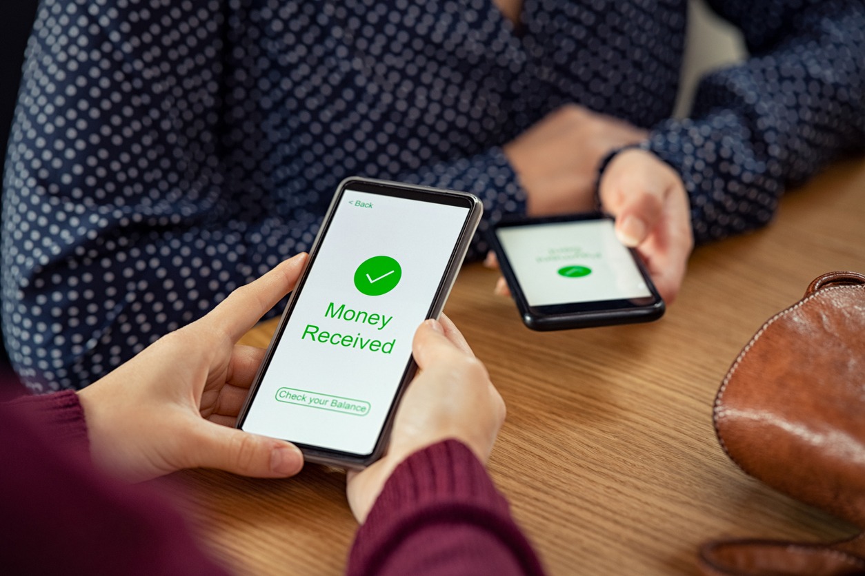 Close up of smartphone screen displaying payment sent with money received message