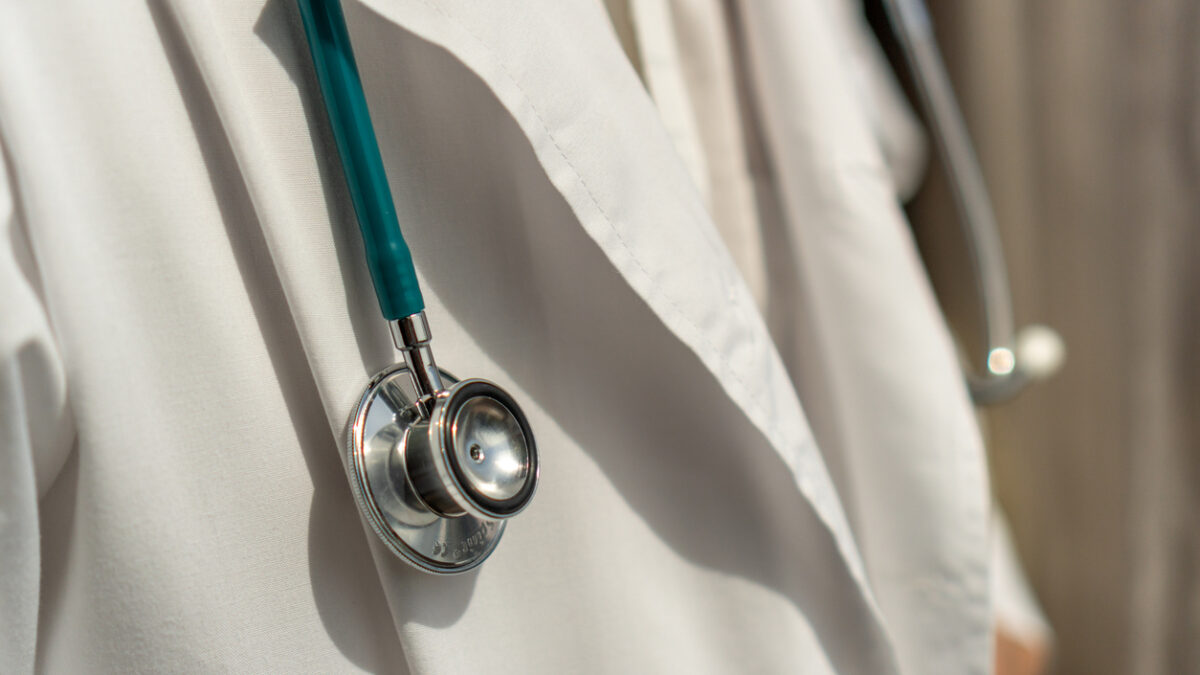 Medical doctor or physician in white gown uniform with stethoscope in hospital or clinic fighting with COVID-19 with laboratory background banner