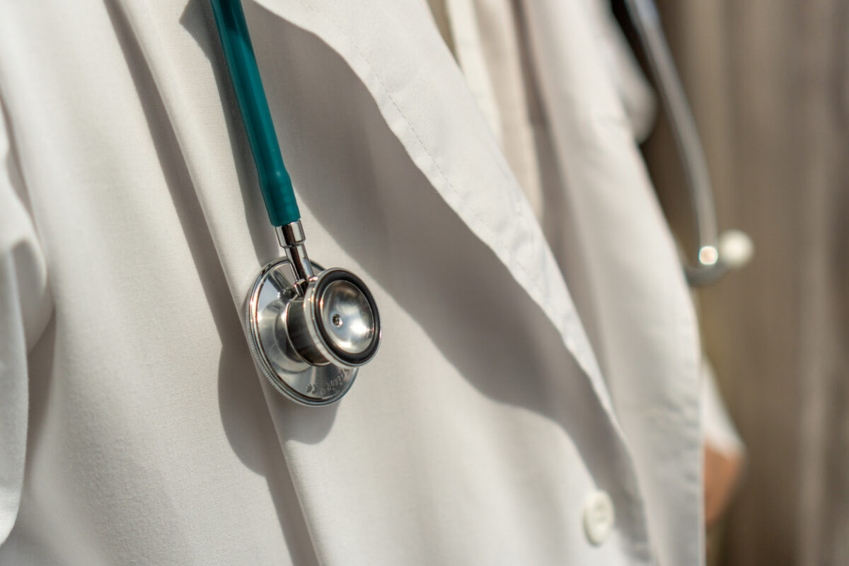 Medical doctor or physician in white gown uniform with stethoscope in hospital or clinic fighting with COVID-19 with laboratory background banner