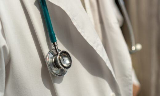 Medical doctor or physician in white gown uniform with stethoscope in hospital or clinic fighting with COVID-19 with laboratory background banner