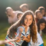 Group of children pulling a rope in public park
