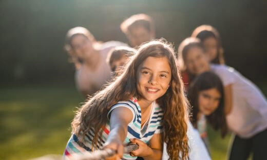 Group of children pulling a rope in public park