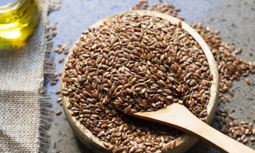 Flax seeds in a wooden bowl.