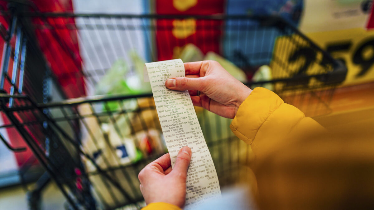 Woman checking the bill when paying at a supermarket