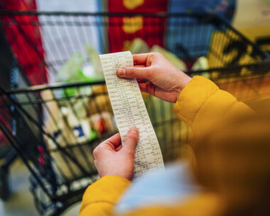 Woman checking the bill when paying at a supermarket