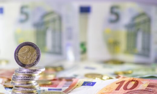 Stack of european coins and bank notes in the background show international finance with euro and europe, european trade and financial trade as well as saving, financial success and credit management