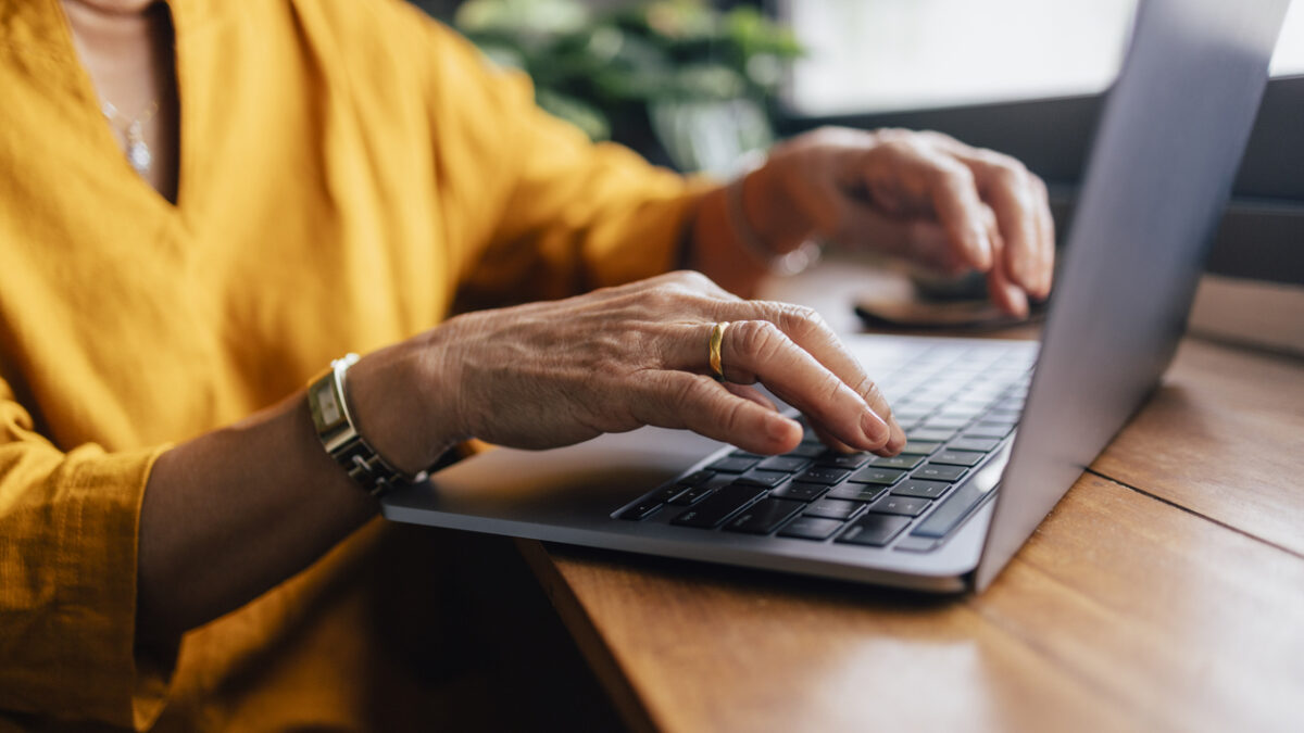 Close up shot of an woman typing on her laptop