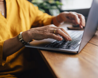 Close up shot of an woman typing on her laptop