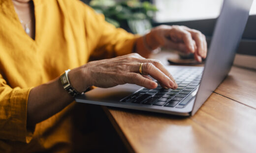 Close up shot of an woman typing on her laptop