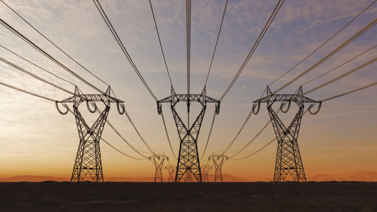The silhouette of the high voltage power lines during sunset