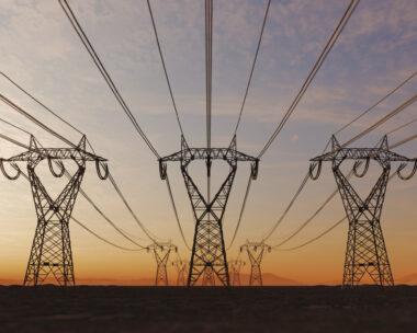 The silhouette of the high voltage power lines during sunset