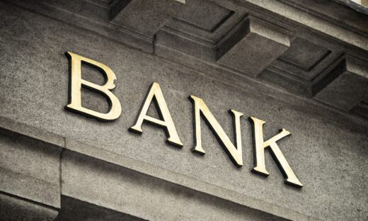 An old fashioned 'Bank' sign on a building exterior.