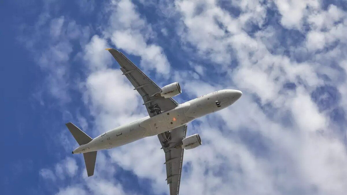 aircraft flying over the camera with landing gears down and ready to land