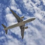 aircraft flying over the camera with landing gears down and ready to land
