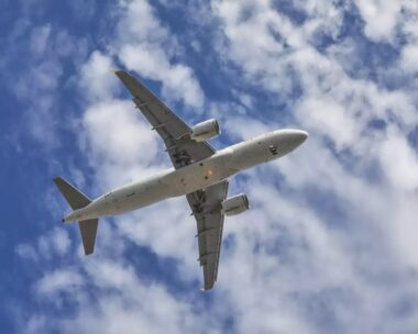 aircraft flying over the camera with landing gears down and ready to land