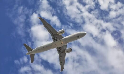 aircraft flying over the camera with landing gears down and ready to land