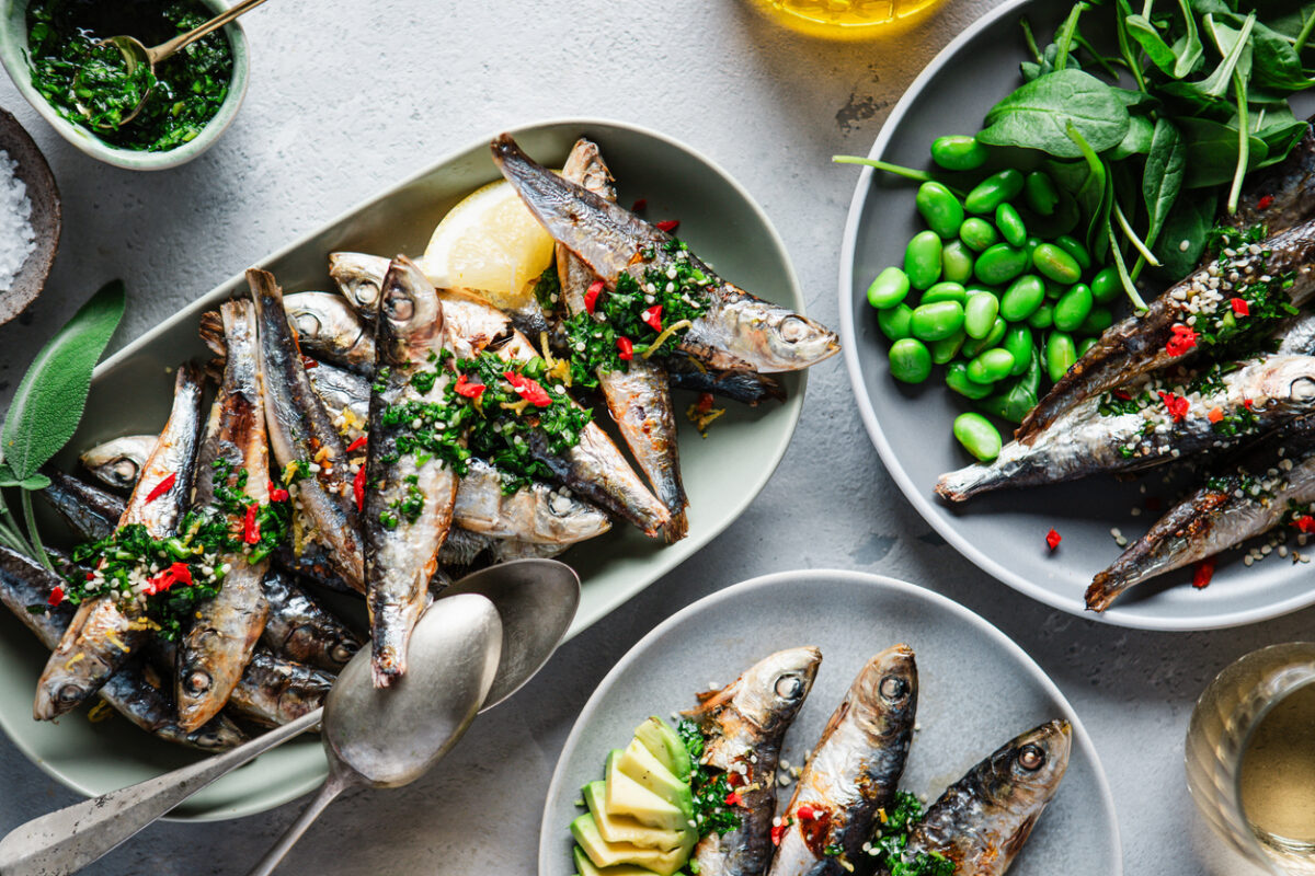 Top view of spicy seafood served on dinner table. Freshly prepared fish dishes with vegetables on kitchen table.