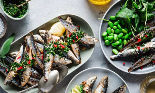 Top view of spicy seafood served on dinner table. Freshly prepared fish dishes with vegetables on kitchen table.