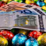 Close up of money and colorful chocolate eggs