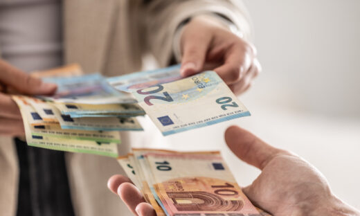 Businesswoman's hands exchanging euro banknotes
